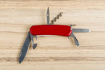 Multipurpose knife on wooden background with all neccessary tools all in oneの写真素材