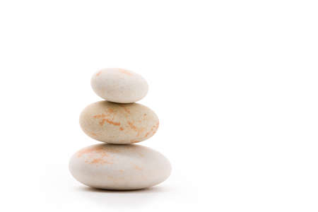 Pile of balancing pebble stones, like ZEN stone, isolated on white background, spa tranquil scene conceptの写真素材