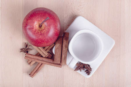 apple cinnamon and empty white cup, wooden background, pastel retro colorの写真素材
