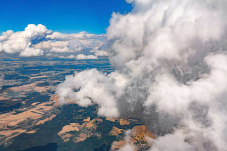 view of the earth landscape from an airplane above the clouds