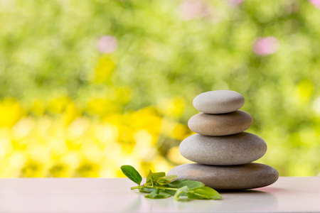 Pile of balancing pebble stones, like ZEN stone, outdoor in spring, spa wellness tranquil scene, soul equanimity concept, mental calmnessの写真素材