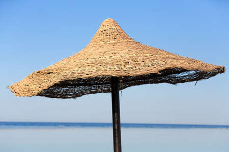 Beach umbrella and blue sky background in egypt paradise beach. vholiday summer acation concept. No People.の写真素材