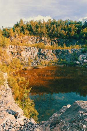 abandoned and flooded quarry, Czech Republic, teal and orange color tone. Beautiful landscape.の写真素材
