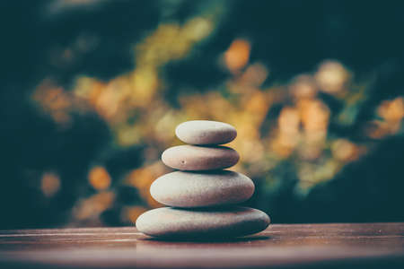 balancing zen pebble stones outdoor, spa wellness tranquil scene, soul equanimity concept, mental calmness, abstract retro colorsの写真素材
