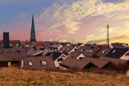 Sunset over residential area in Heligoland. Top view on roof of traditional colorful holiday homes. Island Helgoland, Germanyの写真素材