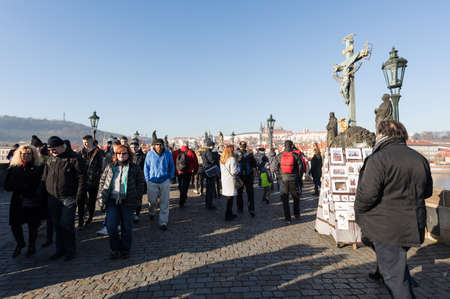 PRAGUE, CZECH REPUBLIC - DECEMBER 3, 2016: Charles Bridge in first advent, in December christmas time with crowd of tourist. It is a popular tourist attraction in Prague. December 3, 2016 Prague, Czech Republic.のeditorial素材