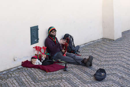 PRAGUE, CZECH REPUBLIC - DECEMBER 3, 2016: Old musician with vintage musical instrument behind Prague castle. December 3, 2016 Prague, Czech Republic.のeditorial素材