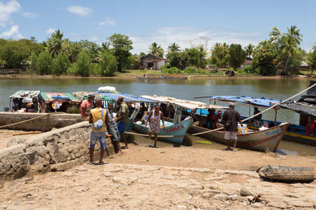MADAGASCAR OCTOBER 18.2016 Malagasy peoples waiting on port for taxi boat at embankment of river Antainambalana in city Maroantsetra, Toamasina Province. Peoples everyday life in Madagascar. October 18. 2016, Madagascarのeditorial素材