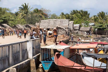 MADAGASCAR OCTOBER 18.2016 Malagasy peoples waiting on port for taxi boat at embankment of river Antainambalana in city Maroantsetra, Toamasina Province. Peoples everyday life in Madagascar. October 18. 2016, Madagascarのeditorial素材