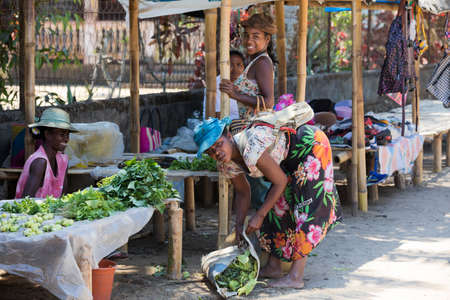 MAROANTSETRA ,MADAGASCAR OCTOBER 18.2016 Malagasy peoples on big colorful rural marketplace on main street of Maroantsetra city. Everyday ordinary life on street. Madagascar, October 18. 2016のeditorial素材