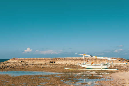 traditional catamaran boat, Bali Indonesia, Nusa Penida island with blue sky, no people. Paradise beach. In a few years this beach full of peopleの写真素材