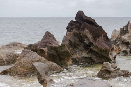 Beautiful pure nature landscape, Masoala National Park, Madagascar overcast picturesque wilderness nature scene with rock on indian ocean.の写真素材