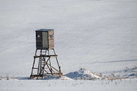 scenery with frozen european highland landscape in winter with hunting tower in sunny dayの写真素材