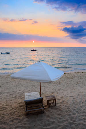 Sunset over Madagascar Nosy be beach with sunlounger and parasol. Africa vacation travel concept.の写真素材