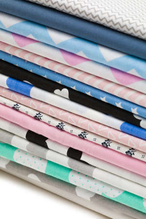 Stack of 100% cotton fabric material for tailor or homework isolated on white