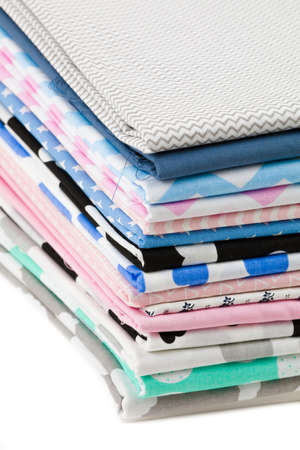 Stack of 100% cotton fabric material for tailor or homework isolated on white