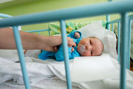 newborn baby infant in the hospital, the first hours of the new life, one days after birth