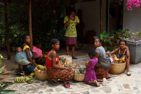 NOSY BE ,MADAGASCAR - NOVEMBER 3.2016 Malagasy women preparing baskets of fruit for street market sale. Nosy be, Madagascar, November 3. 2016のeditorial素材
