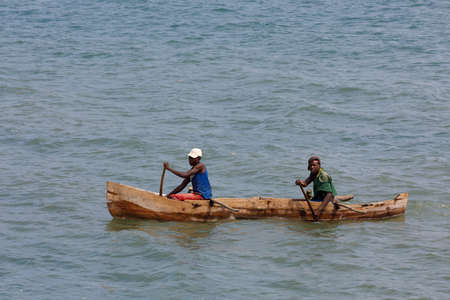 NOSY BE ,MADAGASCAR - NOVEMBER 3.2016 Malagasy man on sea in traditional handmade dugout wooden boat. Everyday life on Nosy be island. Nosy be, Madagascar, November 3. 2016のeditorial素材