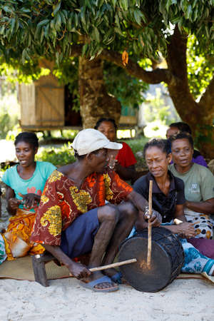 MADAGASCAR OCTOBER 23. 2016 Malagasy woman from village singing traditional songs for tourists on village main street. Countryside Madagascar celebration scene. October 23. 2016, Madagascar.のeditorial素材