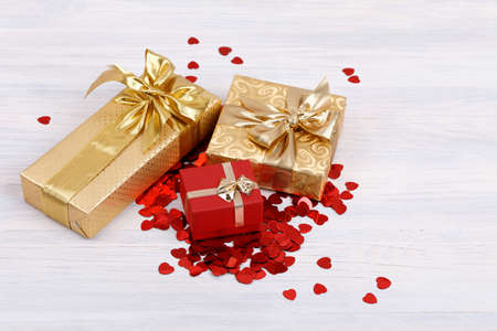 small red hearts confetti and present box on retro vintage wooden backgroundの写真素材