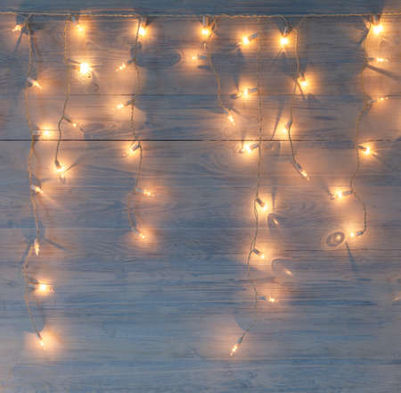 white christmas lights on retro vintage wooden backgroundの写真素材