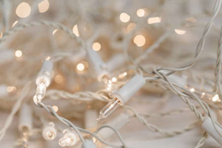 white christmas lights on retro vintage wooden background with shallow focusの写真素材