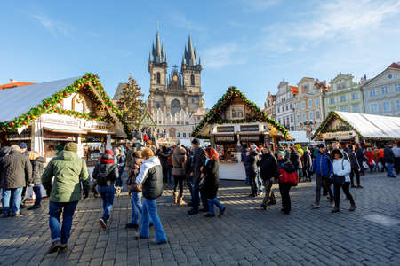 PRAGUE, CZECH REPUBLIC - DECEMBER 9, 2017: Peoples on the famous advent Christmas market at Old Town Square with christmas tree in Prague. It is very popular destination with tourists visiting Prague. December 9, 2017 Prague, Czech Republic.のeditorial素材