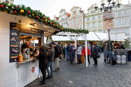 PRAGUE, CZECH REPUBLIC - DECEMBER 9, 2017: Peoples on the famous advent Christmas market at Old Town Square with christmas tree in Prague. It is very popular destination with tourists visiting Prague. December 9, 2017 Prague, Czech Republic.のeditorial素材