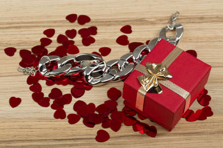 Valentine love gift box and small red hearts confetti