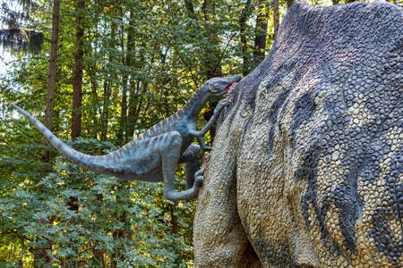 Big model of prehistoric dinosaur Troodon attack parasaurolophus. Realistic scenery.の写真素材