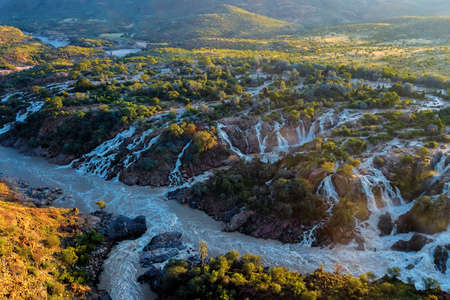 famous Epupa Falls on the Kunene River in Northern Namibia and Southern Angola border. Sunrise sunlight in water mist. This is africa. Beautiful landscape.の写真素材
