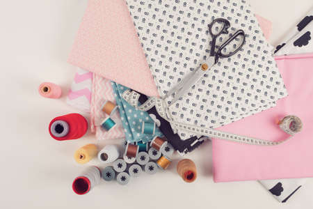 top view of cotton fabric material for tailor or homework, sewing concept with yellow tailor's...