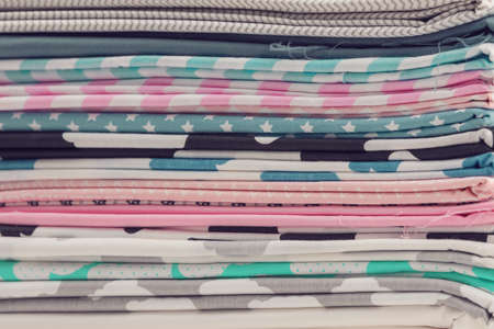Stack of 100% cotton fabric material for tailor or homework, sewing concept