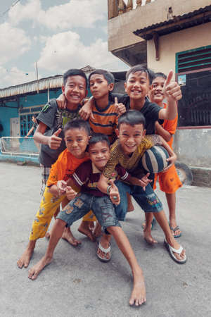 Manado, Indonesia - August 03 2015: Group of young teenagers pose for tourist in street of Manado on North Sulawesi.のeditorial素材