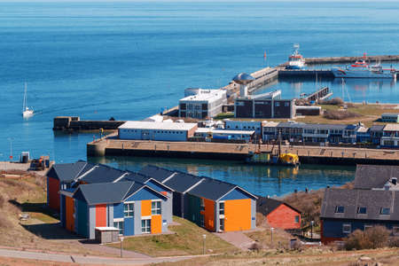 harbor in Island Helgoland, Germany, nordic style houses with boat and blue sky, panorama view from hill to north seaの写真素材