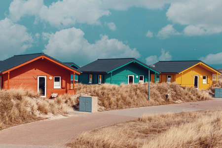 colorful wooden tiny houses on the island Dune near island Helgoland against blue sky.の写真素材