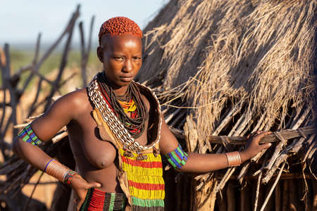 Turmi, Omo River Valley, Ethiopia - May 10, 2019: Portrait of a Hamar woman in village. The Hamer...