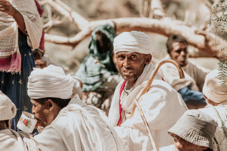 LALIBELA, ETHIOPIA, MAY 1st. 2019, Orthodox Christian Ethiopian believer in front of famous rock-hewn St. George's Church after Mass on May 1st. 2019 in Lalibela, Ethiopiaのeditorial素材