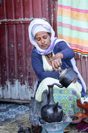 LALIBELA, ETHIOPIA, MAY 1st. 2019, Ethiopian traditional Coffee ceremony, local women preparing street bunna cafe on May 1st. 2019 in Lalibela, Ethiopiaのeditorial素材