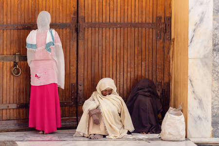 AXUM, ETHIOPIA, APRIL 27th.2019: Orthodox believers sitting in front of famous Church of Our Lady of Zion on April 27, 2019 in Aksum, Ethiopia Africaのeditorial素材
