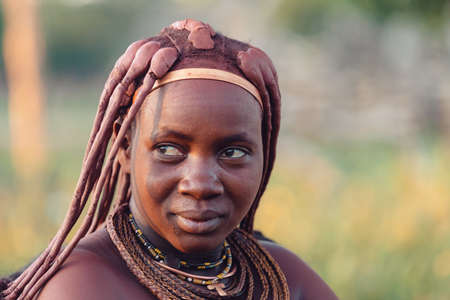 NAMIBIA, OMUSATI REGION, MAY 6: Portrait of Himba woman with traditional hairstyle and necklaces around her neck. The Himba are indigenous namibian ethnic people, in northern Namibia, May 6, 2018, Namibiaのeditorial素材