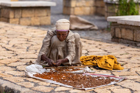 AXUM, ETHIOPIA, APRIL 27th.2019: Old woman on the street in front of famous Church of Our Lady of...