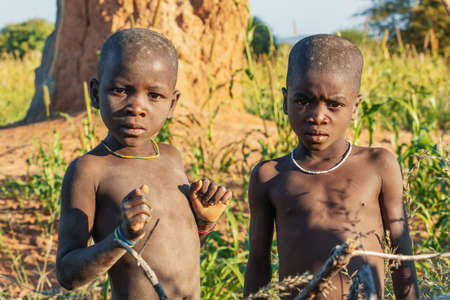 NAMIBIA, OMUSATI REGION, MAY 6: The Himba boys playing at the termite mound. The Himbas are african indigenous namibian ethnic people, in northern Namibia, May 6, 2018, Namibia Africaのeditorial素材