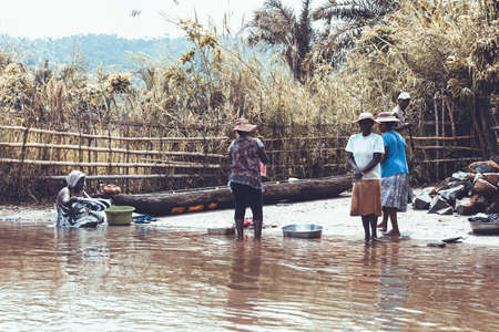MAROANTSETRA, MADAGASCAR OCTOBER 19.2016: Malagasy woman washes laundry in local river...