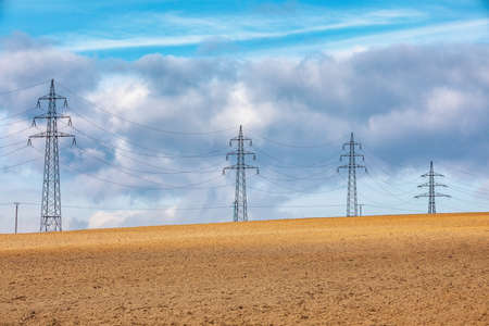 high voltage power lines in field against a blue sky. Europe Czech Republicの写真素材