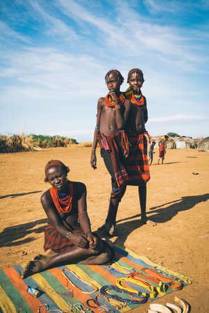 Omorate, Omo Valley, Ethiopia - May 11, 2019: Woman from the African tribe Dasanesh offering handmade souvenirs. Daasanach are Cushitic ethnic group inhabiting in Ethiopia, Kenya, and South Sudanのeditorial素材