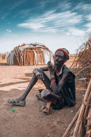 Omorate, Omo Valley, Ethiopia - May 11, 2019: Portrait of man from the African tribe Dasanesh. Daasanach are Cushitic ethnic group inhabiting in Ethiopia, Kenya, and South Sudanのeditorial素材