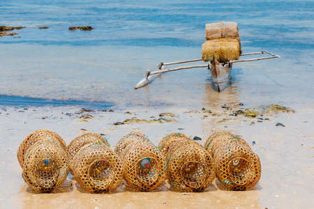 traditional malagasy bamboo woven crustacean fishing trap on beach in Nosy Be. Madagascar countryside scene.の写真素材