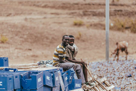 GONDAR, ETHIOPIA, APRIL 22.2019, Truck drivers sitting on spilled cargo after accident on a country road. Gondar, Ethiopia, April 22, 2019のeditorial素材